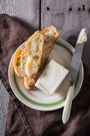 French baguette with butter for breakfastの写真素材