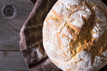 Freshly baked traditional bread on wooden tableの写真素材