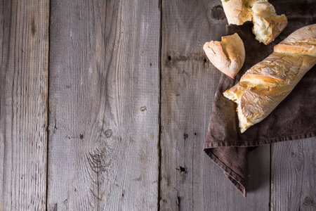 Homemade baguettes on wooden table