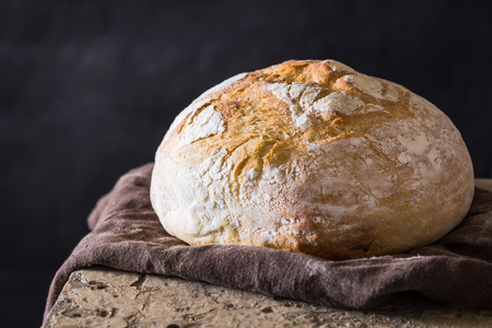 Homemade bread loaf on old table. Dark backgroundの写真素材