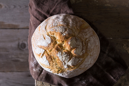 Freshly baked traditional bread on wooden tableの写真素材