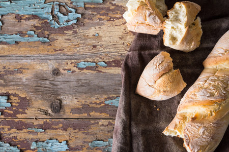 Homemade baguettes on wooden table