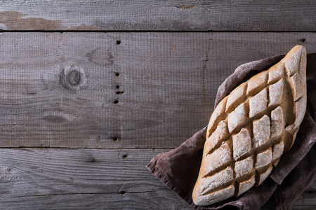 Freshly baked traditional bread on wooden tableの写真素材