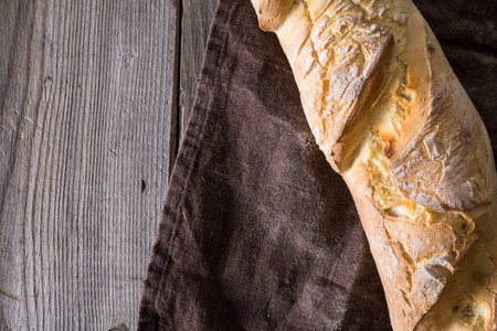 Homemade baguettes on wooden table