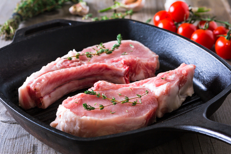 Raw steaks in grill pan ready to cook. Wooden backgroundの写真素材