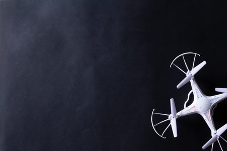 Photo of white quadrocopter on black backgroundの写真素材