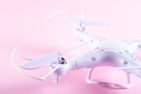 Photo of white quadrocopter on bright pink backgroundの写真素材