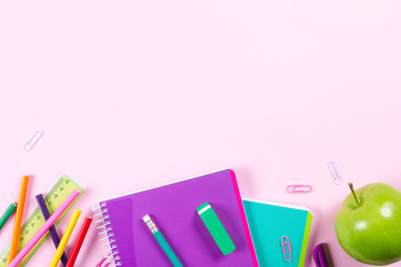School stationery on pink background with copyspace. Flat layの写真素材