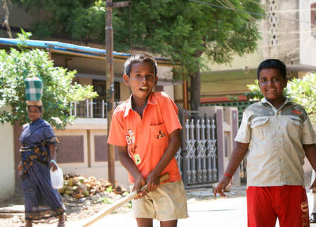 October 5, 2008, Madurai, India. Two boys play cricket in the street.のeditorial素材