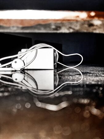 Reflection of a charger n earphoneの写真素材
