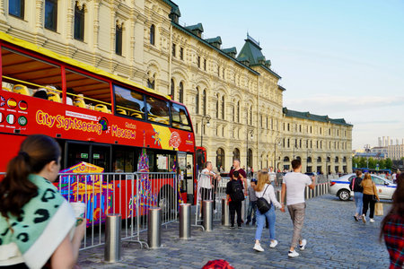 MOSCOW, Russia - August 2020: Tourists sit in a red tourist double-decker bus near Kremlin on Red...