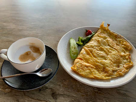 A plate of mexican omelet food and a cup of coffee Healthy lunchの写真素材