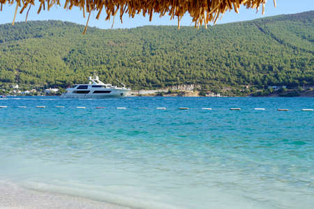 Panoramic Paradise view of the purest turquoise lagoon of the Aegean Sea near Bodrum with boats and yachts, white sand and green mountains Paradise Luxury tourism conceptの写真素材