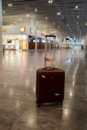 Bodrum, Turkey - August, 2020: Red suitcase in the arrival hall at the airport, Travel concept. Lost luggage, Travelling conceptのeditorial素材