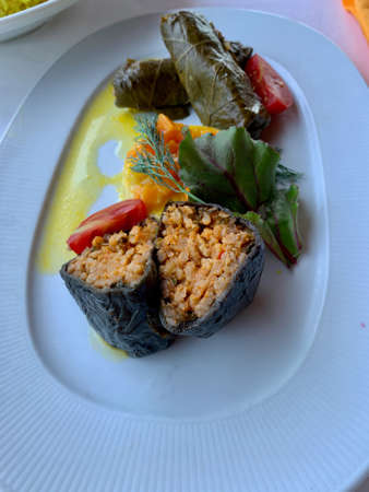 Very tasty delicacies with arugula, seafood, eggs on a plate in the restaurantの写真素材