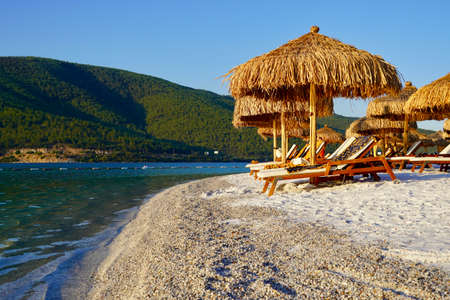 Bodrum, Turkey - August, 2020 tropical paradise beach with of Hotel Lujo with white sand and coco palms travel tourism wide panorama background concept with parasol. Luxury tourism conceptionのeditorial素材