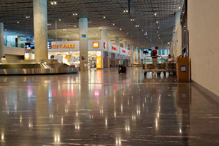 Bodrum, Turkey - August, 2020: Arrivals hall with glittering store windows of Duty Free stores at Bodrum airport. Beautiful modern Bodrum Airportのeditorial素材
