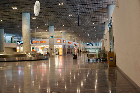 Bodrum, Turkey - August, 2020: Arrivals hall with glittering store windows of Duty Free stores at Bodrum airport. Beautiful modern Bodrum Airportのeditorial素材
