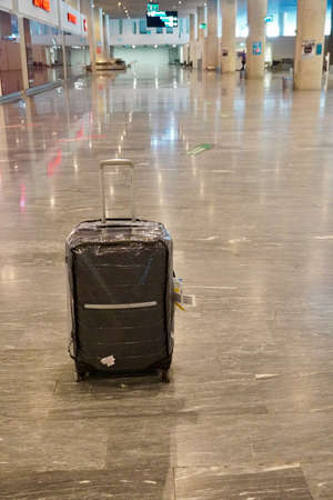 Bodrum, Turkey - August, 2020: A suitcase in the arrivals hall. Looking for luggage. Lost luggage. World Tourism. Empty airports during the pandemicのeditorial素材