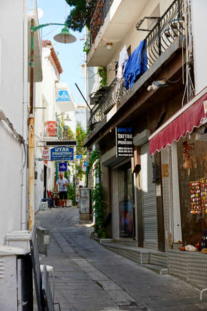 Bodrum, Turkey - August, 2020: View of white street and flowers in Bodrum city of Turkey. Aegean style colorful streetのeditorial素材