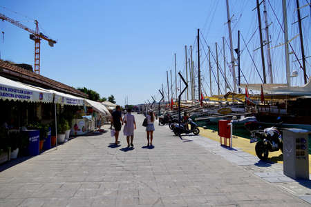 Bodrum, Mugla. Turkey - August, 2020: View of a bay and the marina. Small traditional fishing boats, yachts and gulets.The mountain.のeditorial素材