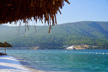 Bodrum, Turkey - August, 2020 Tropical beach panorama as summer landscape with white sand and calm sea for beach banner. Tranquil beach scene vacation and summer holiday concept. Boost up color process. Lujo Lux hotelHigh quality photoの写真素材