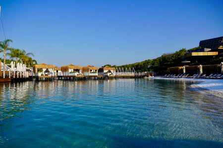 View of nice empty sandy beach with some tropical bungalow.の写真素材