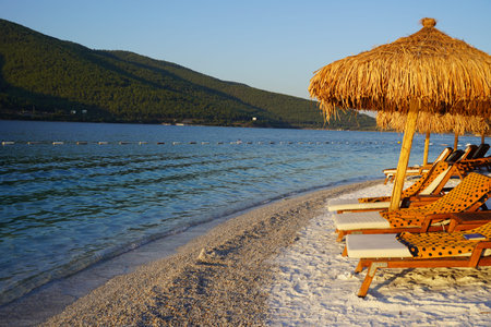 Hotel beach Lujo. Beautiful tropical beach banner. White sand travel tourism wide panorama background concept. Amazing beach landscape, yachts, Luxury tourism, Sand beach with some grass umbrellas at the luxury resort.の写真素材