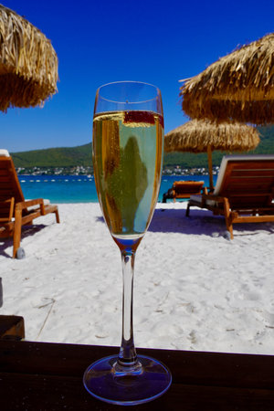 Cool Ice Champaigne with raspberry on a tropical white sand beach beautiful romantic sea viewの写真素材