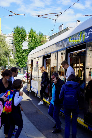 Moscow, Russia - September,2020 Modern models of Trams as Moscow public Transport and Passengers at Tram stop in Moscow. Patriarshije Prudi stop. Tram stopped and People come in and outのeditorial素材