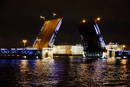 Saint Petersburg. Russia. Panoramic view. The Palace bridge is divorced. Raising of the bridges. Bridges Of Petersburg. View from the Neva to the Hermitage. Winter palace in the evening. Panorama of the city. Blue illuminated of the bridge. One of the main landscapes of Saint-Petersburgの写真素材