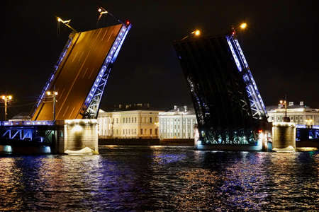 Saint Petersburg. Russia. Panoramic view. The Palace bridge is divorced. Raising of the bridges. Bridges Of Petersburg. View from the Neva to the Hermitage. Winter palace in the evening. Panorama of the city. Blue illuminated of the bridge. One of the main landscapes of Saint-Petersburgの写真素材