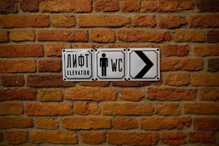 Sign Staircase WC on the red brick wall