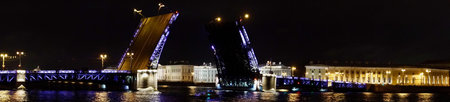 Saint Petersburg. Russia. Panoramic view. The Palace bridge is divorced. Raising of the bridges. Bridges Of Petersburg. View from the Neva to the Hermitage. Winter palace in the evening. Panorama of the city. Blue illuminated of the bridge. One of the main landscapes of Saint-Petersburgの写真素材