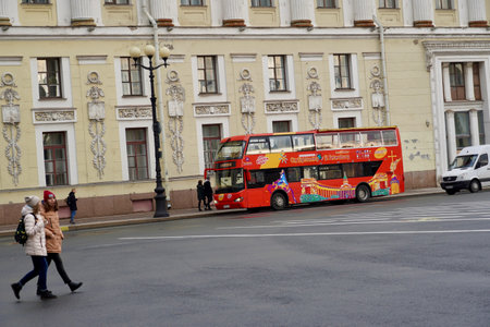 St. Petersburg, Russia - November, 2020 Sightseeing Tour Buses in Front of Saint Isaacs Cathedral. Hop On Hop Off Tourist Bus and Group Tour Red Bus for Guided Tours on Empty Street with Copy Space. Double Decker bus for tourists. North capital of Russiaのeditorial素材