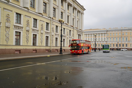 St. Petersburg, Russia - November, 2020 Sightseeing Tour Buses in Front of Saint Isaacs Cathedral. Hop On Hop Off Tourist Bus and Group Tour Red Bus for Guided Tours on Empty Street with Copy Space. Double Decker bus for tourists. North capital of Russiaのeditorial素材
