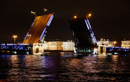 Saint Petersburg. Russia. Panoramic view. The Palace bridge is divorced. Raising of the bridges. Bridges Of Petersburg. View from the Neva to the Hermitage. Winter palace in the evening. Panorama of the city. Blue illuminated of the bridge. One of the main landscapes of Saint-Petersburgの写真素材