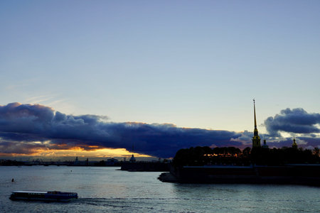 Stunning Panoramic view of Tain-Petersburg at sunrise. Peter and Paul Fortress is original citadel of St. Petersburg, Russia, founded by Peter Great in 1703 and built to Trezzinis designs as star fortress. Peter and Paul Fortress. View across Neva river. Waterfront Big Neva, Dramatic sky,の写真素材