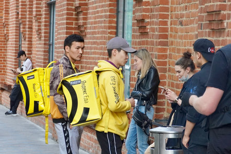 Moscow, Russia - September 2020 Couriers Yandex food delivery with large yellow bag-refrigerator on the streets of Moscow. Street Viewのeditorial素材