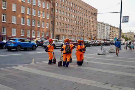 Moscow, Russia - September 2020 Road workers in orange vests on the streets of Moscow. Urban street...