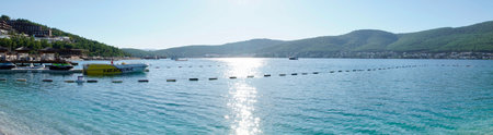 Bodrum, Turkey - August, 2020 Stunning panoramic view of island with palm trees, white sand, turquoise ocean water and blue sky, Water bungalow, white boatsのeditorial素材