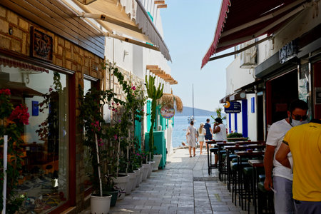 Bodrum, Turkey - August, 2020: Atmospheric Narrow street in old town. Daily atmosphere in Turkey. Bouganville flowersのeditorial素材