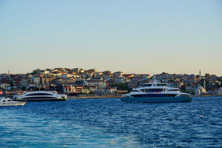 Bubbling blue waves of traces of tourist cruise ships passing on the Bosporus. Water trail foaming behind a passenger ferry boat in Bosphorus, Istanbul, Turkey.の写真素材