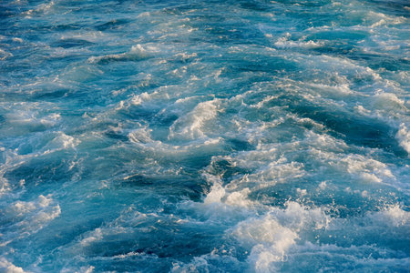 Bubbling blue waves of traces of tourist cruise ships passing on the Bosporus. Water trail foaming...
