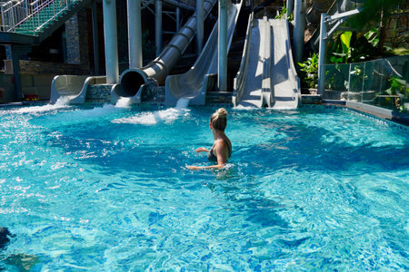 Young woman in pool in aqua parkの写真素材