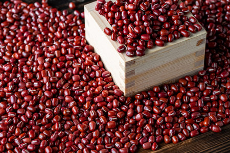 Red adzuki beans in square wooden measuring cup. Organic,healthy food concept.