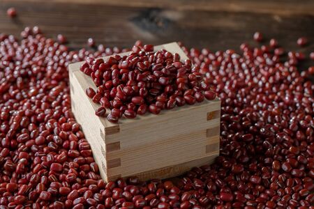 Red adzuki beans in square wooden measuring cup. Organic,healthy food concept.の写真素材