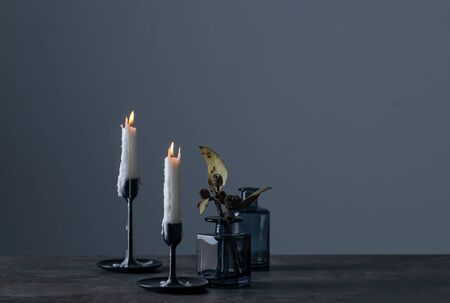 Lighted candles and vases on table. Quiet and chill lifestyle concept image.の写真素材