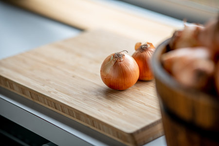 Fresh ripe onions on table in kitchen.の写真素材