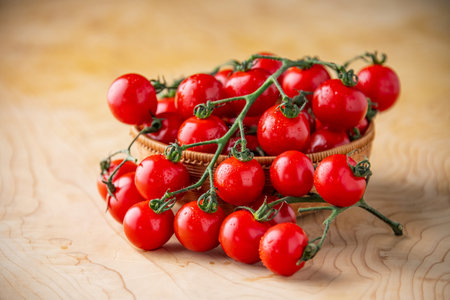 Fresh cherry tomatoes on wooden background.の写真素材